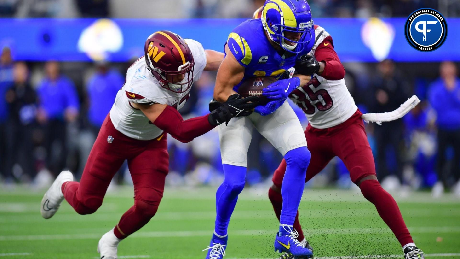 Los Angeles Rams WR Cooper Kupp (10) tries to break tackles against the Washington Commanders.