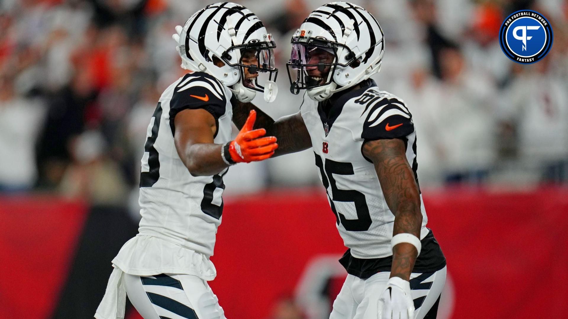 Cincinnati Bengals wide receiver Tee Higgins (85) celebrates with wide receiver Tyler Boyd (83) after scoring a touchdown against the Miami Dolphins at Paycor Stadium.