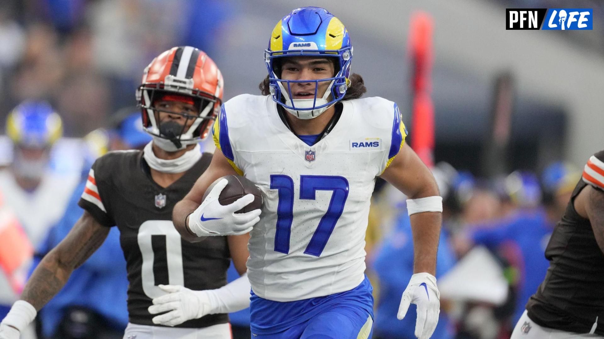 Los Angeles Rams wide receiver Puka Nacua (17) carries the ball against the Cleveland Browns cornerback Greg Newsome II (0) in the second half at SoFi Stadium.