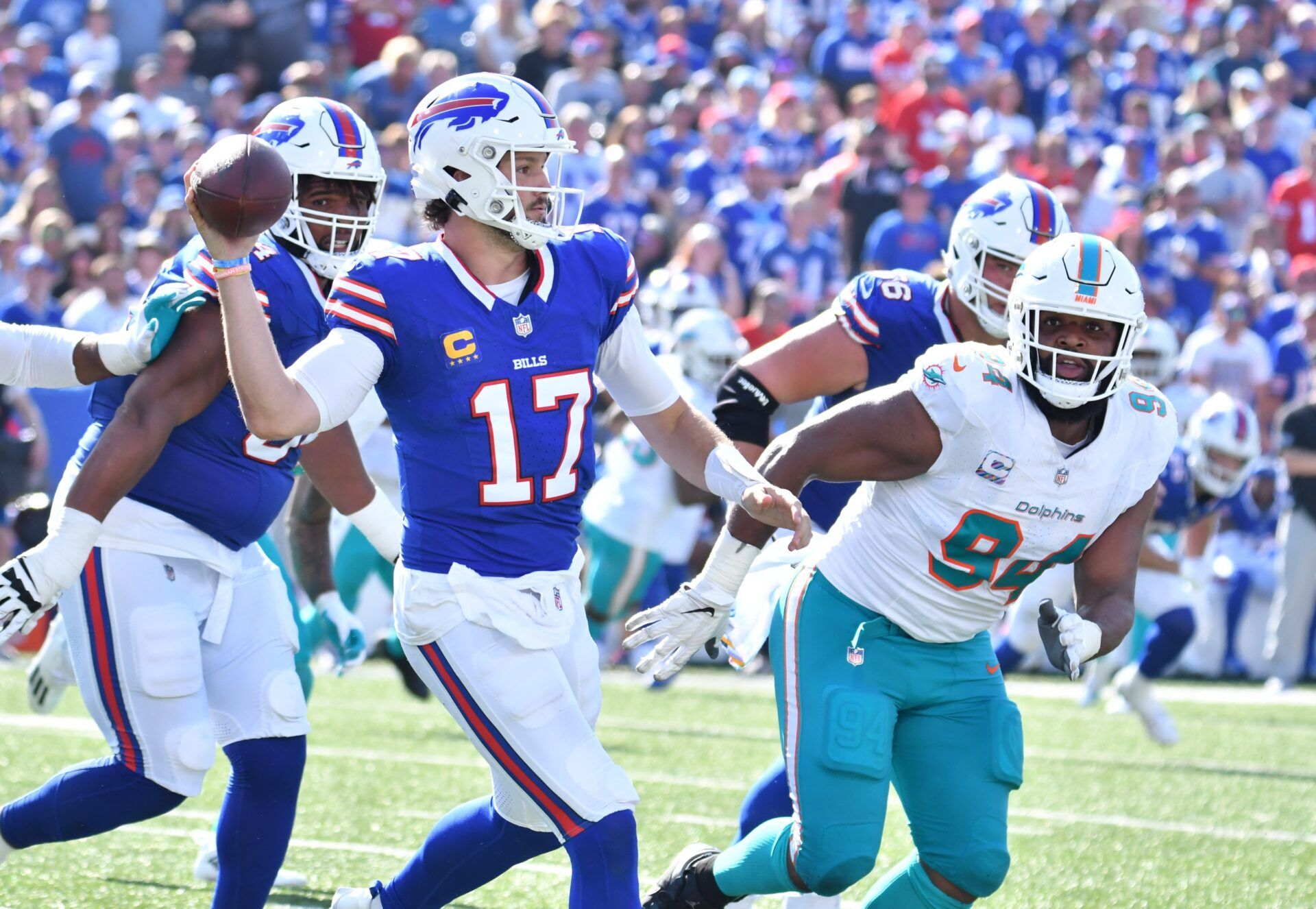 Buffalo Bills quarterback Josh Allen (17) throws a pass as Miami Dolphins defensive tackle Christian Wilkins (94) rushes in the third quarter at Highmark Stadium.