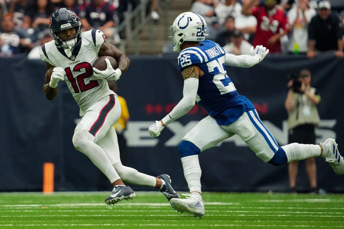 Houston Texans wide receiver Nico Collins (12) evades Indianapolis Colts safety Rodney Thomas II (25) on Sunday, Sept. 17, 2023, during a game at NRG Stadium in Houston.