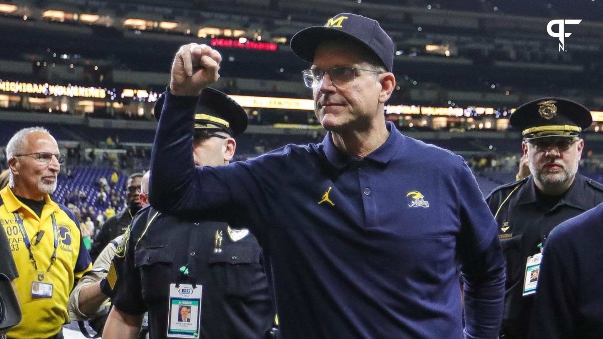 Michigan Wolverines head coach Jim Harbaugh fist pumps in celebration after beating Iowa in the Big Ten Championship.