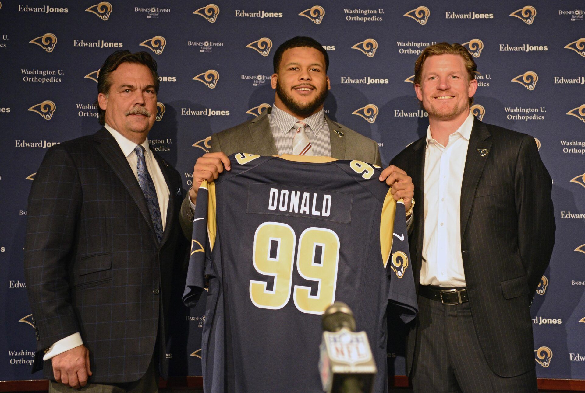 St. Louis Rams head coach Jeff Fisher (left), first-round pick defensive tackle Aaron Donald (middle) and general manager Les Snead pose for a photo after a press conference at Rams Park.