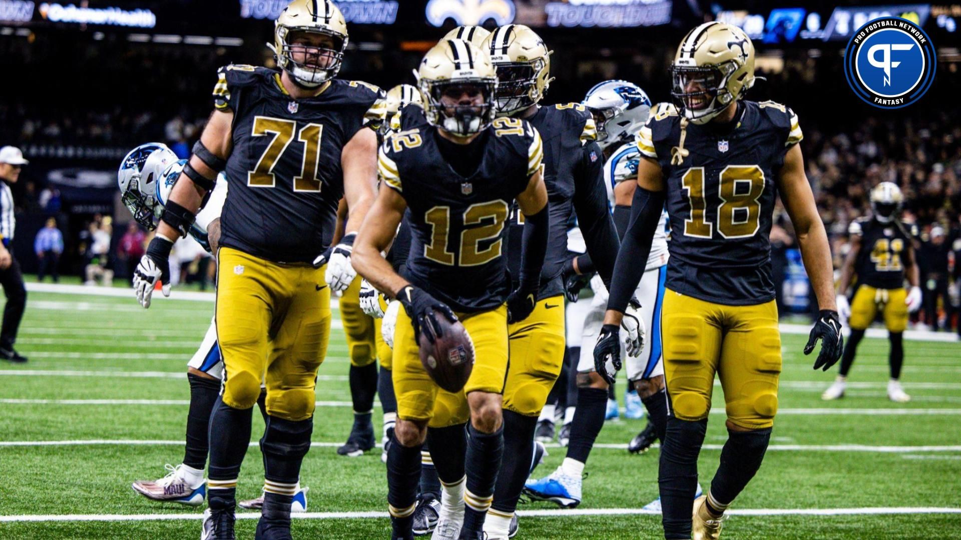 New Orleans Saints wide receiver Chris Olave (12) reacts to making a touchdown against Carolina Panthers safety Vonn Bell (24) during the second half at the Caesars Superdome.