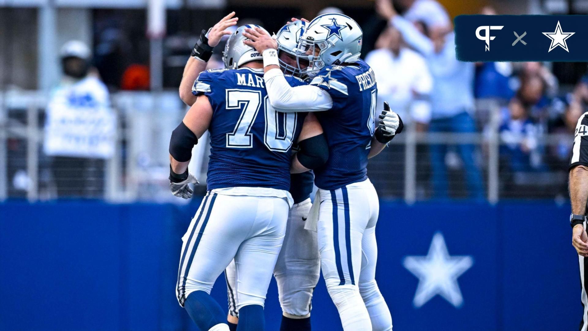 Dallas Cowboys quarterback Dak Prescott (4) and guard Zack Martin (70) celebrates a touchdown scored by running back Tony Pollard (not pictured) during the second half against the Chicago Bears at AT&T Stadium.
