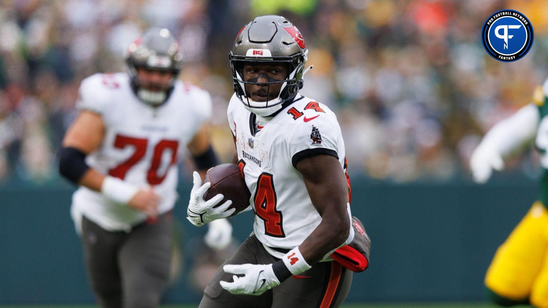 Tampa Bay Buccaneers wide receiver Chris Godwin (14) rushes with the football after catching a pass during the second quarter against the Green Bay Packers at Lambeau Field.