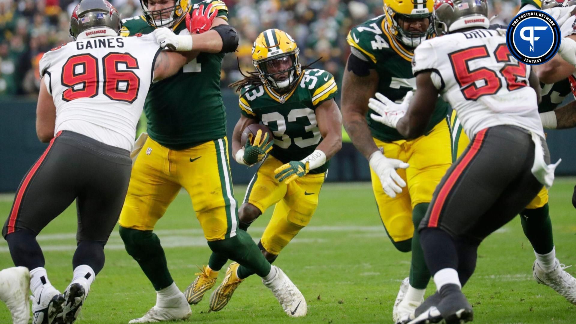 Green Bay Packers running back Aaron Jones (33) looks for room to run against the Tampa Bay Buccaneers during their football game Sunday, December 17, 2023, at Lambeau Field in Green Bay, Wis.