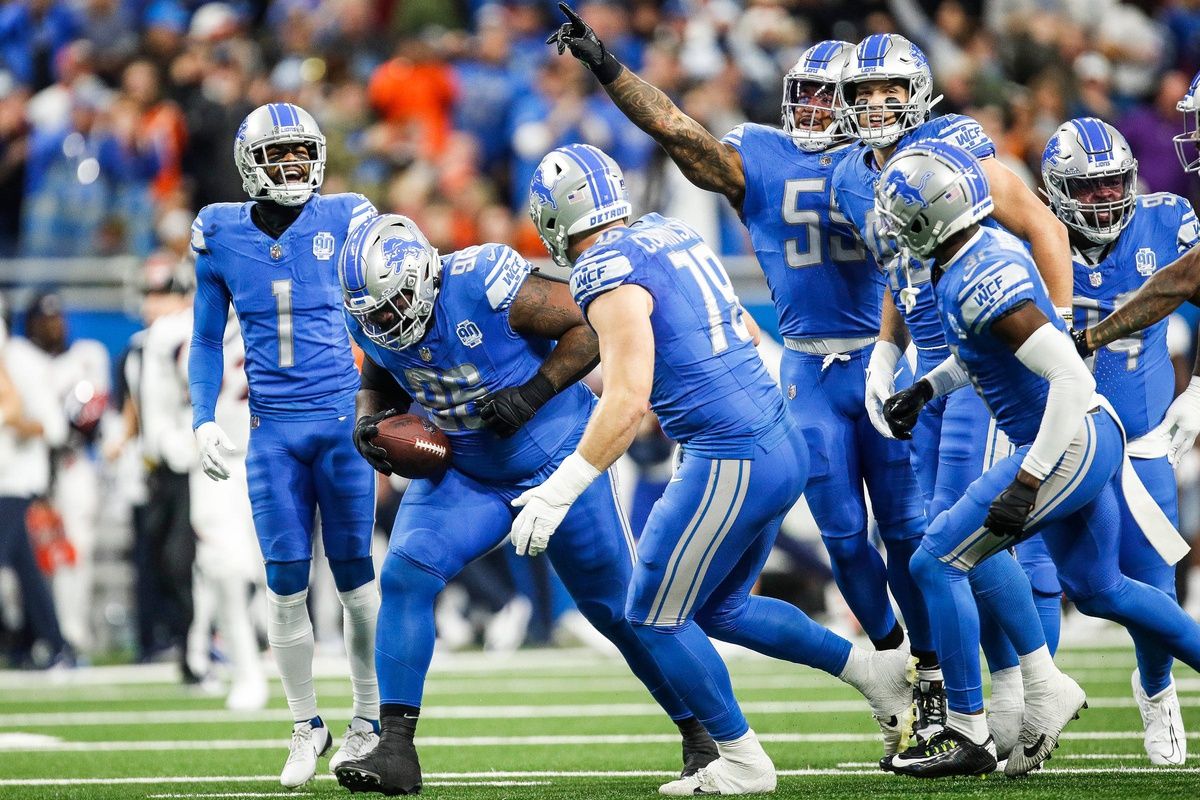 Detroit Lions defensive end Isaiah Buggs (96) celebrates a fumble recovery from Denver Broncos quarterback Russell Wilson (3) with teammates during the first half at Ford Field in Detroit on Saturday, Dec. 16, 2023.