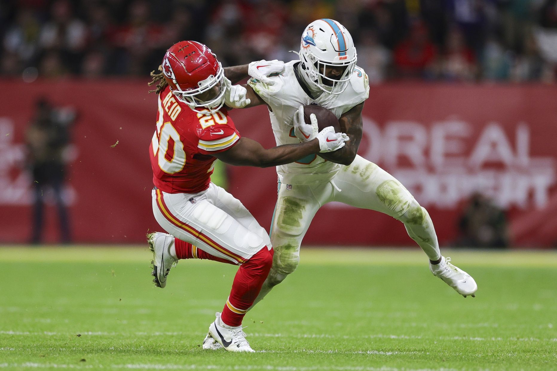 Miami Dolphins running back Raheem Mostert (31) holds off Kansas City Chiefs safety Justin Reid (20) in the fourth quarter during an NFL International Series game at Deutsche Bank Park.