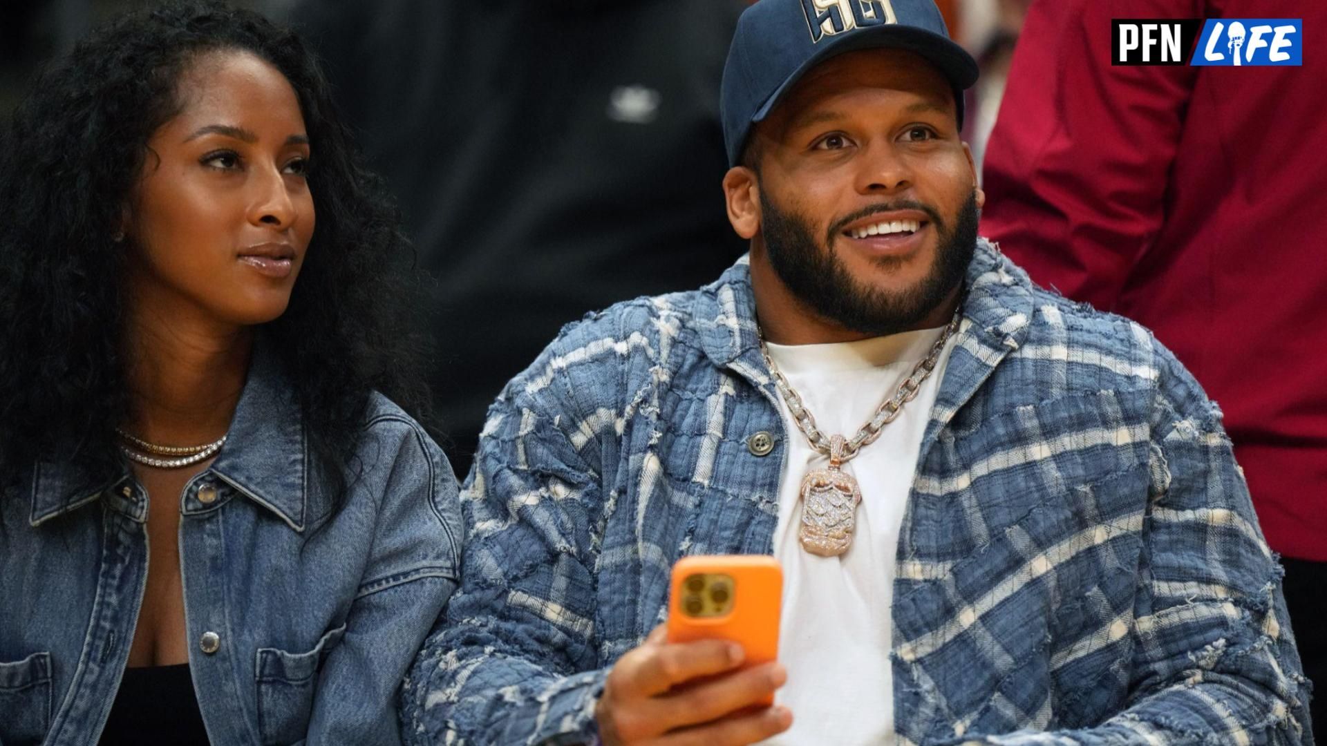 Los Angeles Rams DE Aaron Donald (right) and wife Erica Donald react during the second half of the game between the LA Sparks and the Las Vegas Aces.