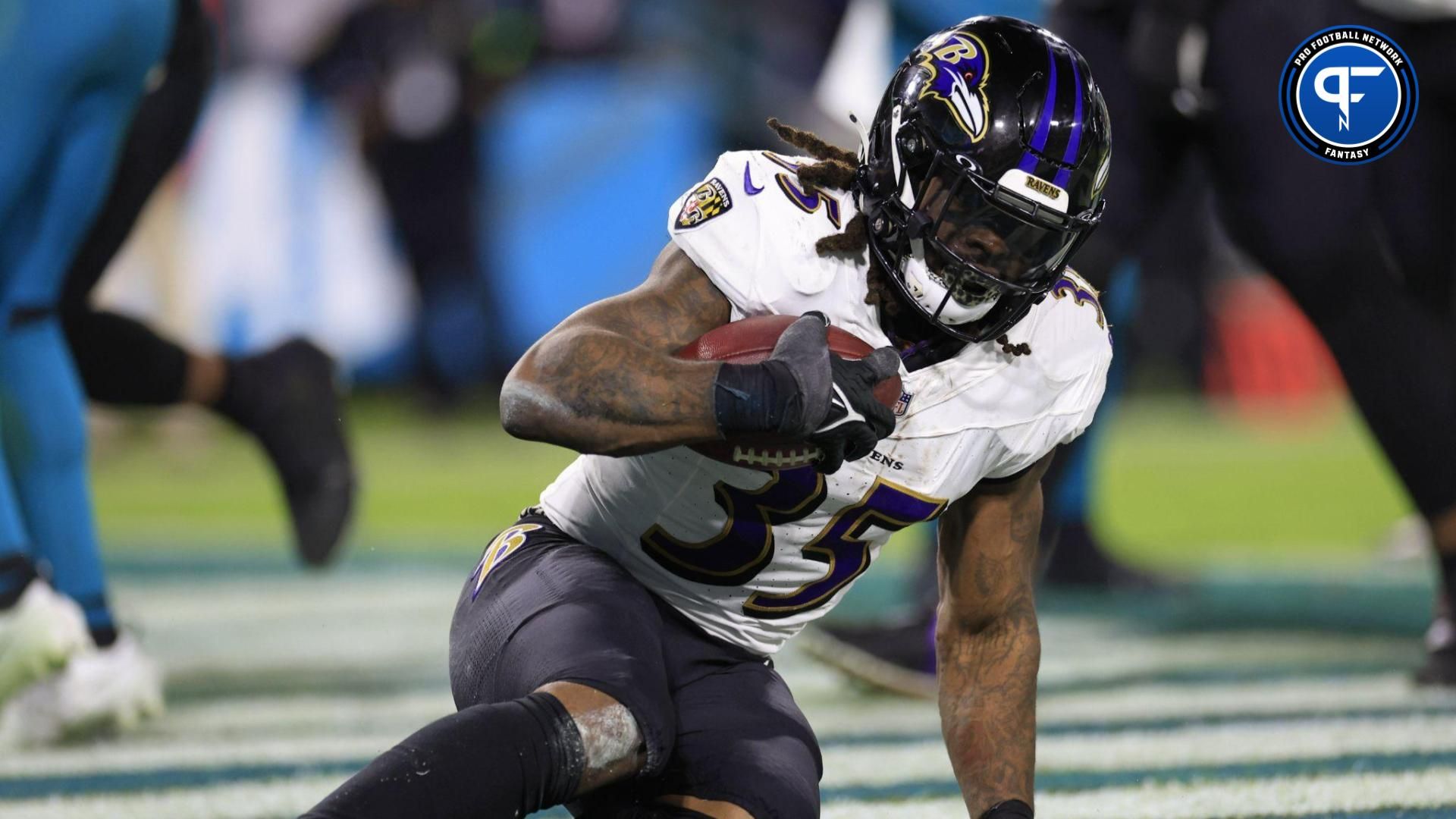 Baltimore Ravens running back Gus Edwards (35) scores a touchdown during the fourth quarter of a regular season NFL football matchup.