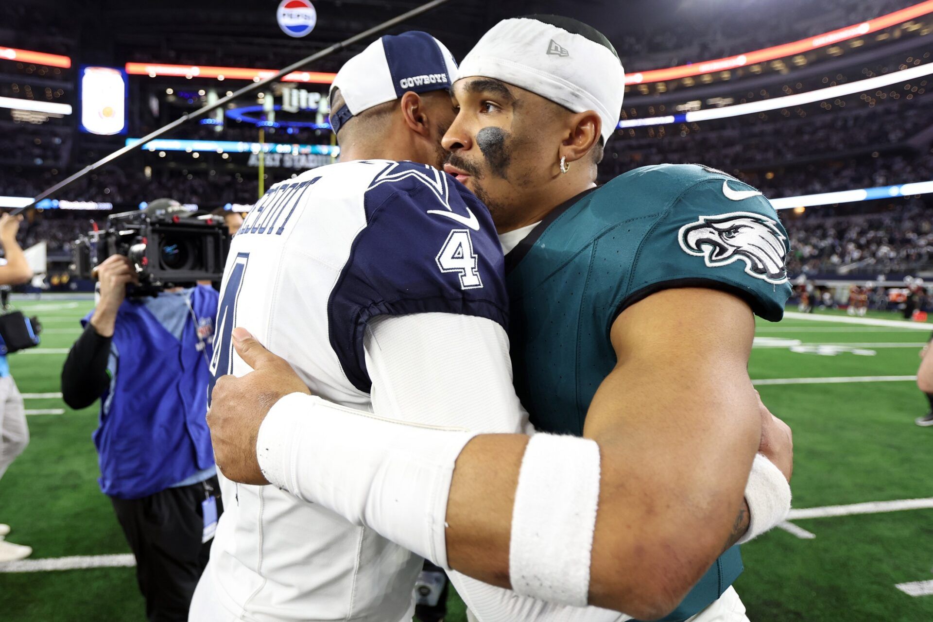 Dallas Cowboys quarterback Dak Prescott (4) hugs Philadelphia Eagles quarterback Jalen Hurts (1) after the game at AT&T Stadium.