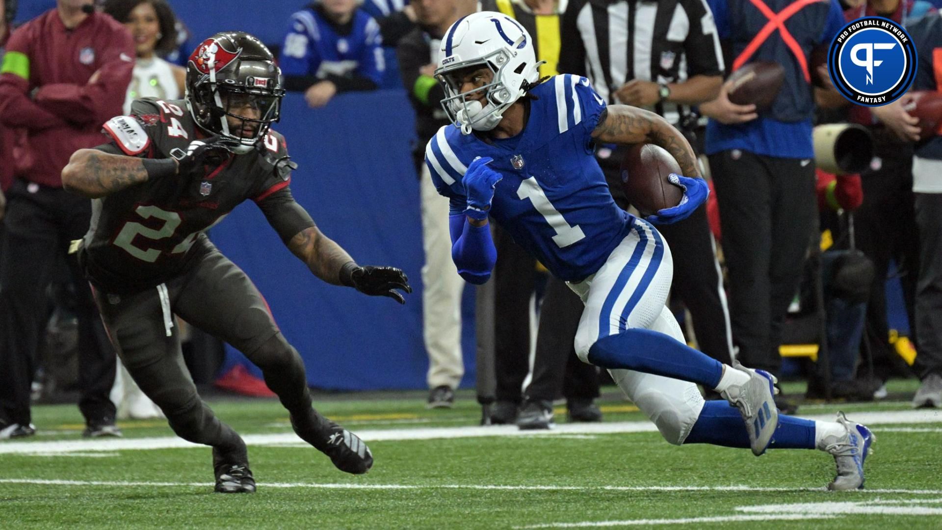 Indianapolis Colts wide receiver Josh Downs (1) looks to run around Tampa Bay Buccaneers cornerback Carlton Davis III (24) during the second quarter at Lucas Oil Stadium.