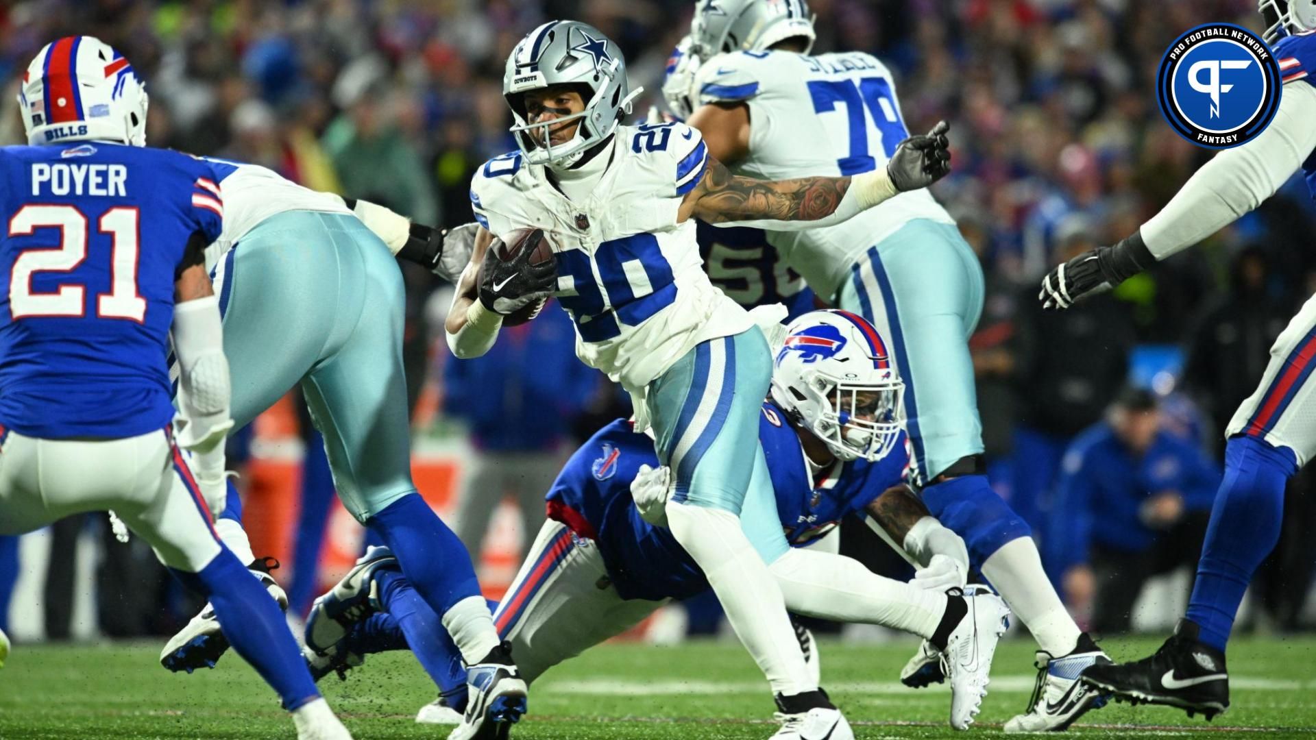 Dallas Cowboys running back Tony Pollard (20) runs the ball pressured by Buffalo Bills linebacker Terrel Bernard (43) in the first half at Highmark Stadium.