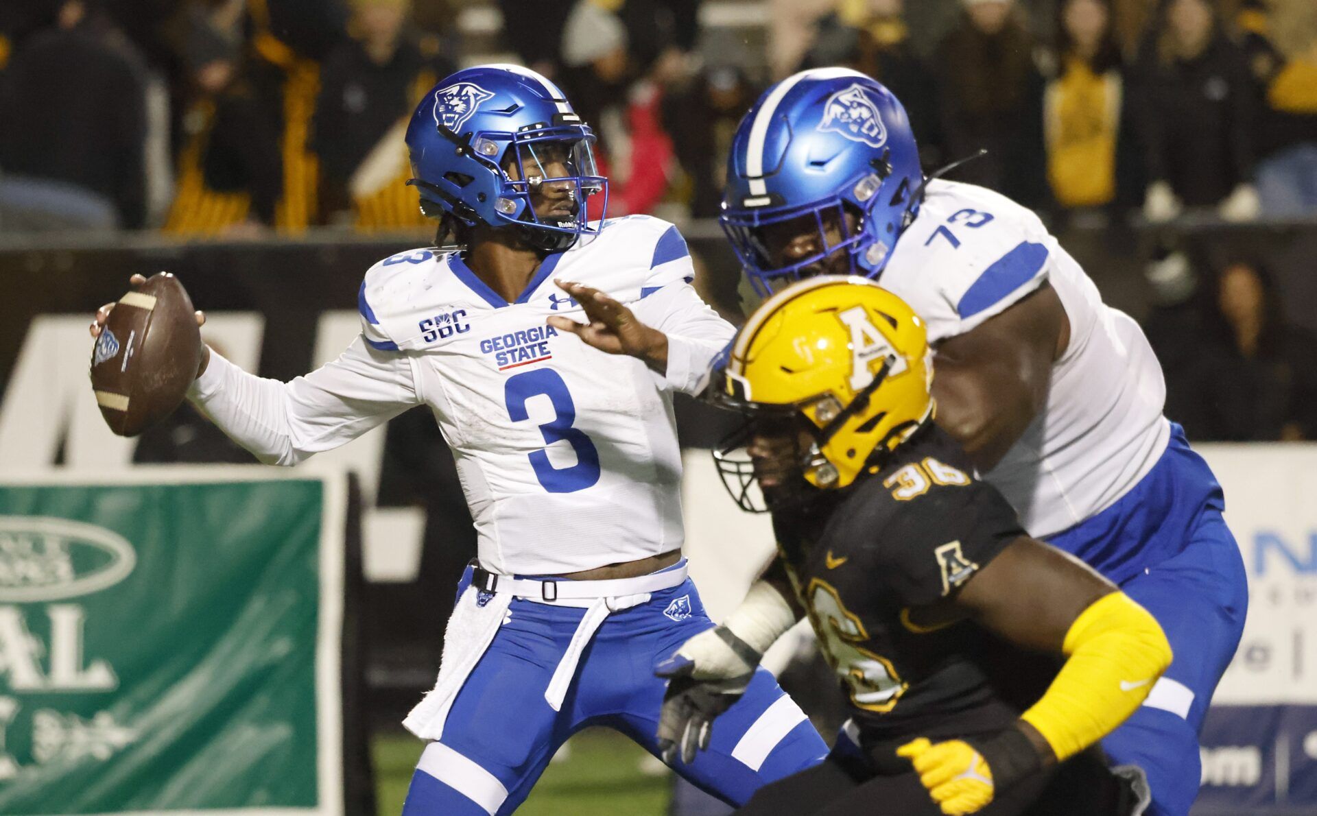 Georgia State Panthers quarterback Darren Grainger (3) throws a pass as offensive tackle Travis Glover (73) blocks the rush of Appalachian State Mountaineers linebacker Kevon Haigler (36) during the second half at Kidd Brewer Stadium.