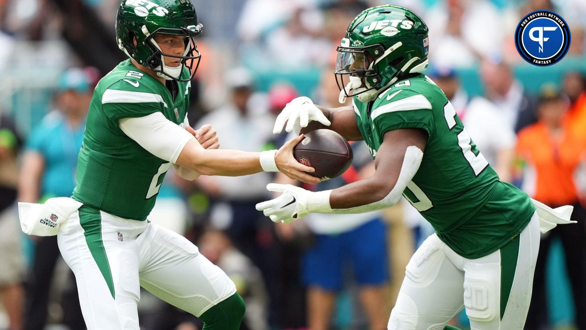 New York Jets quarterback Zach Wilson (2) hands the ball to running back Breece Hall (20) during the first half against the Miami Dolphins at Hard Rock Stadium.