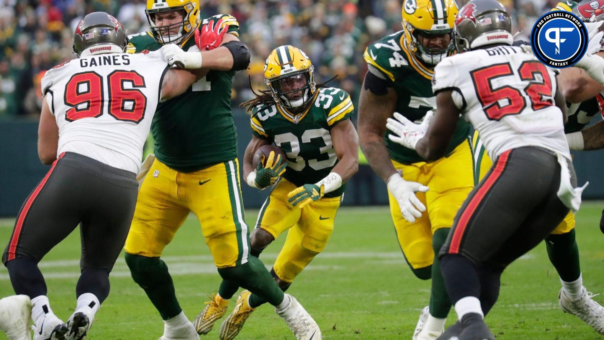 Green Bay Packers running back Aaron Jones (33) looks for room to run against the Tampa Bay Buccaneers during their football game Sunday, December 17, 2023, at Lambeau Field in Green Bay, Wis.