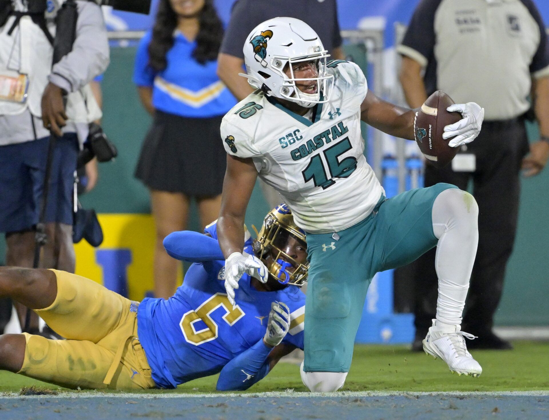 Coastal Carolina Chanticleers wide receiver Sam Pinckney (15) hangs on to a pass in front of UCLA Bruins defensive back John Humphrey (6) for a touchdown in the second half at Rose Bowl.