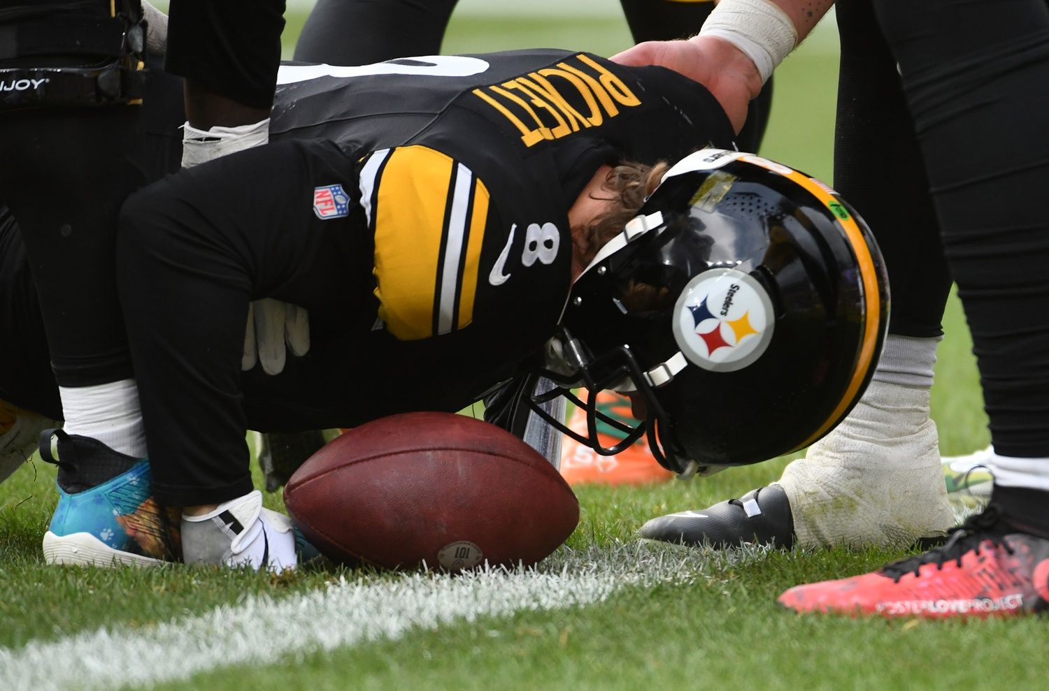 Pittsburgh Steelers quarterback Kenny Pickett (8) is stopped by Arizona Cardinals defensive lineman Jonathan Ledbetter (93) and linebacker Josh Woods (10) during the second quarter at Acrisure Stadium. Pickett left the game with an injury.