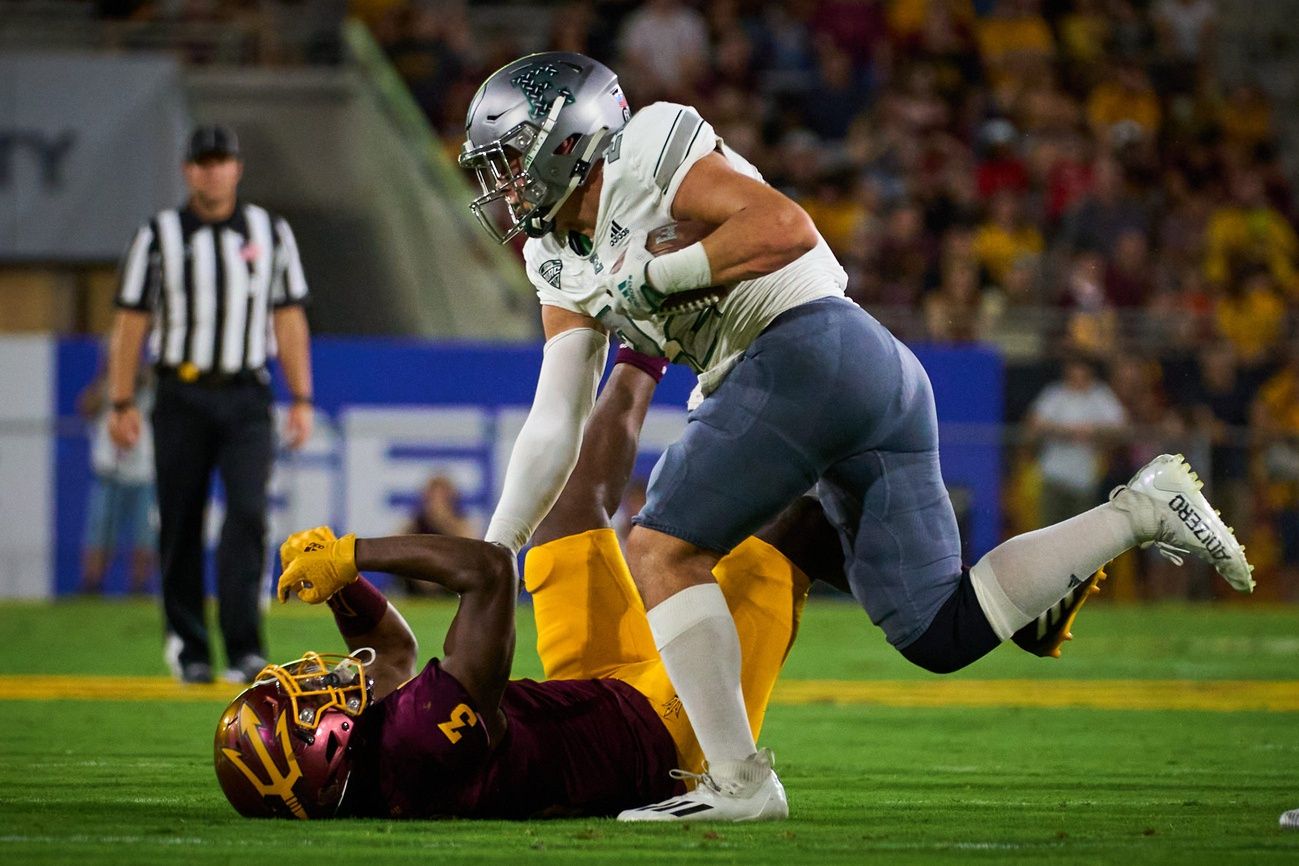 Eastern Michigan Eagles running back Samson Evans (22) pushes Arizona State Sun Devils defensive back D.J. Taylor (3) down at Sun Devil Stadium in Tempe.