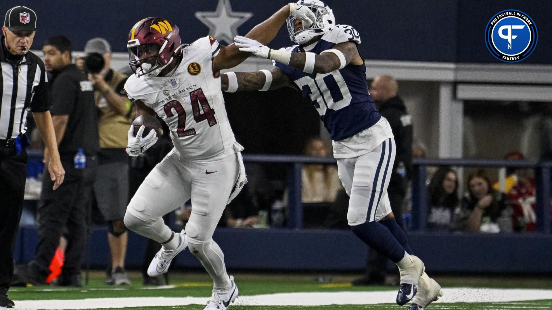 Washington Commanders running back Antonio Gibson (24) and Dallas Cowboys safety Juanyeh Thomas (30) in action during the game between the Dallas Cowboys and the Washington Commanders at AT&T Stadium.