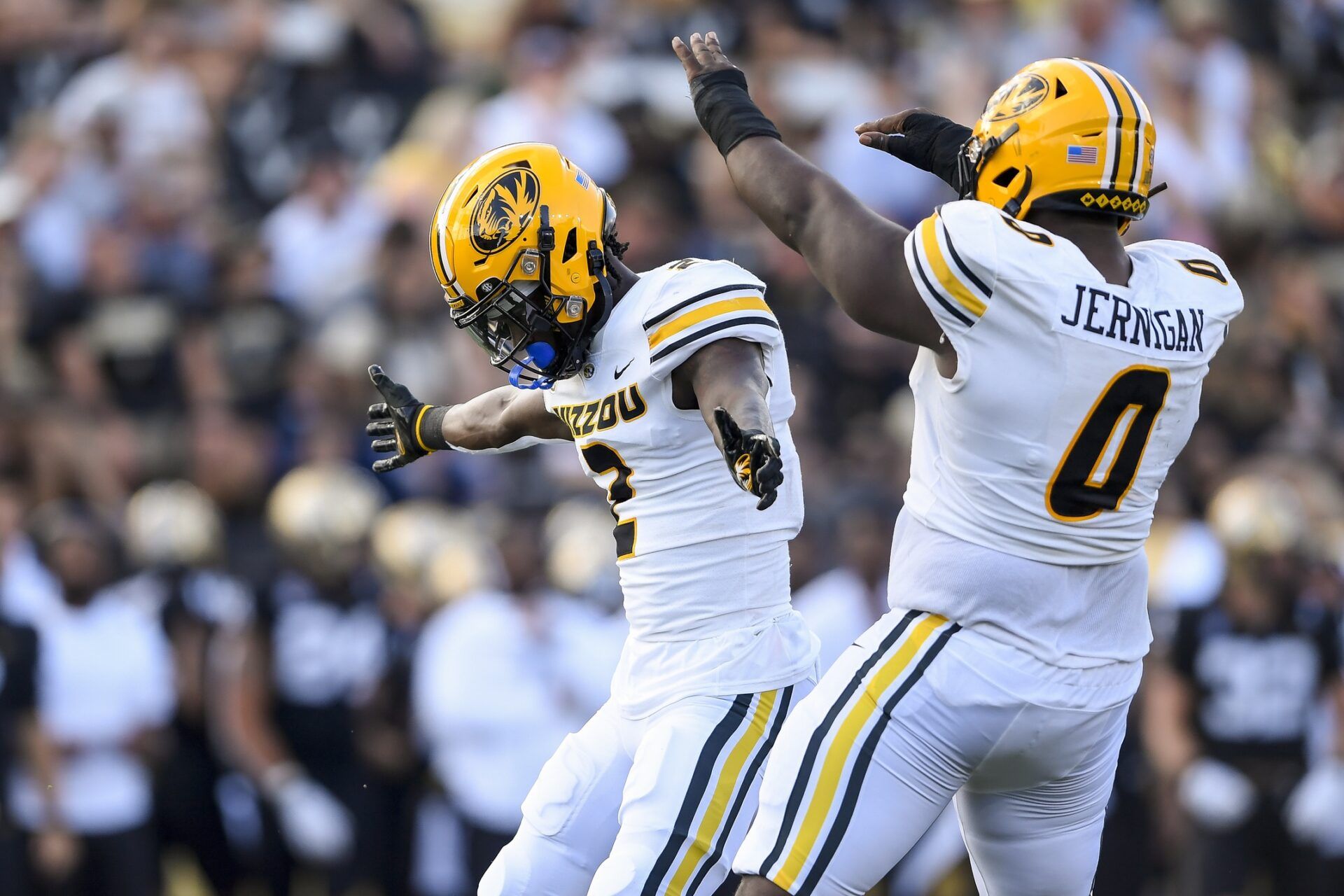 Missouri Tigers safety Ennis Rakestraw Jr. (2) and defensive lineman Jayden Jernigan (0) celebrate Rakestraw Jr.’s tackle for a loss of Vanderbilt Commodores tight end Justin Ball (84) during the first half at FirstBank Stadium.