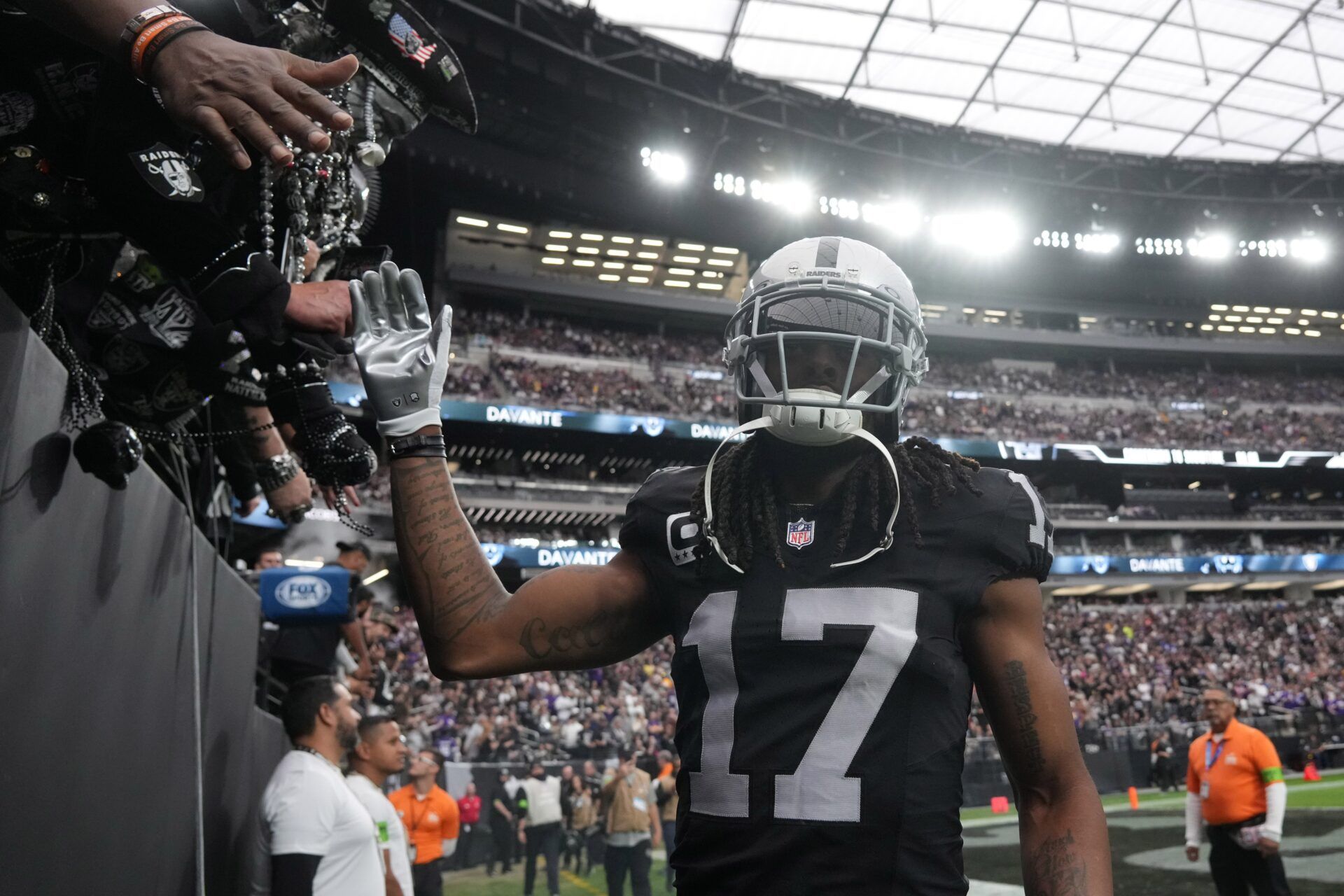 Las Vegas Raiders wide receiver Davante Adams (17) is greeted by fans during teh game against the Minnesota Vikings at Allegiant Stadium.