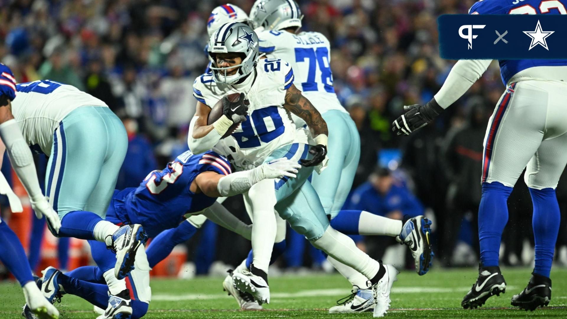 Dallas Cowboys running back Tony Pollard (20) runs the ball pressured by Buffalo Bills linebacker Terrel Bernard (43) in the first half at Highmark Stadium.