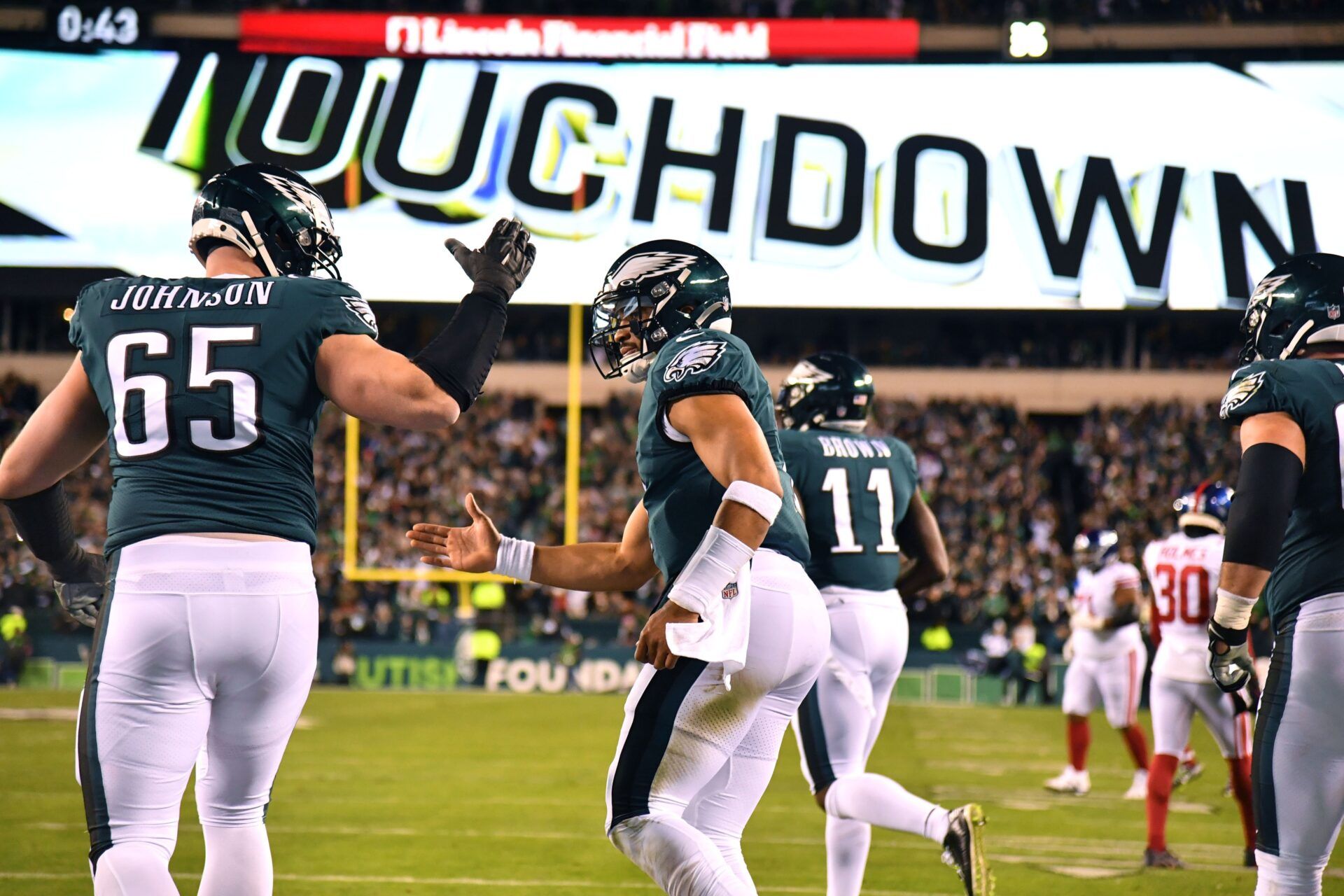 Philadelphia Eagles quarterback Jalen Hurts (1) celebrates his touchdown with offensive tackle Lane Johnson (65) during the second quarter against the New York Giants during an NFC divisional round game at Lincoln Financial Field.