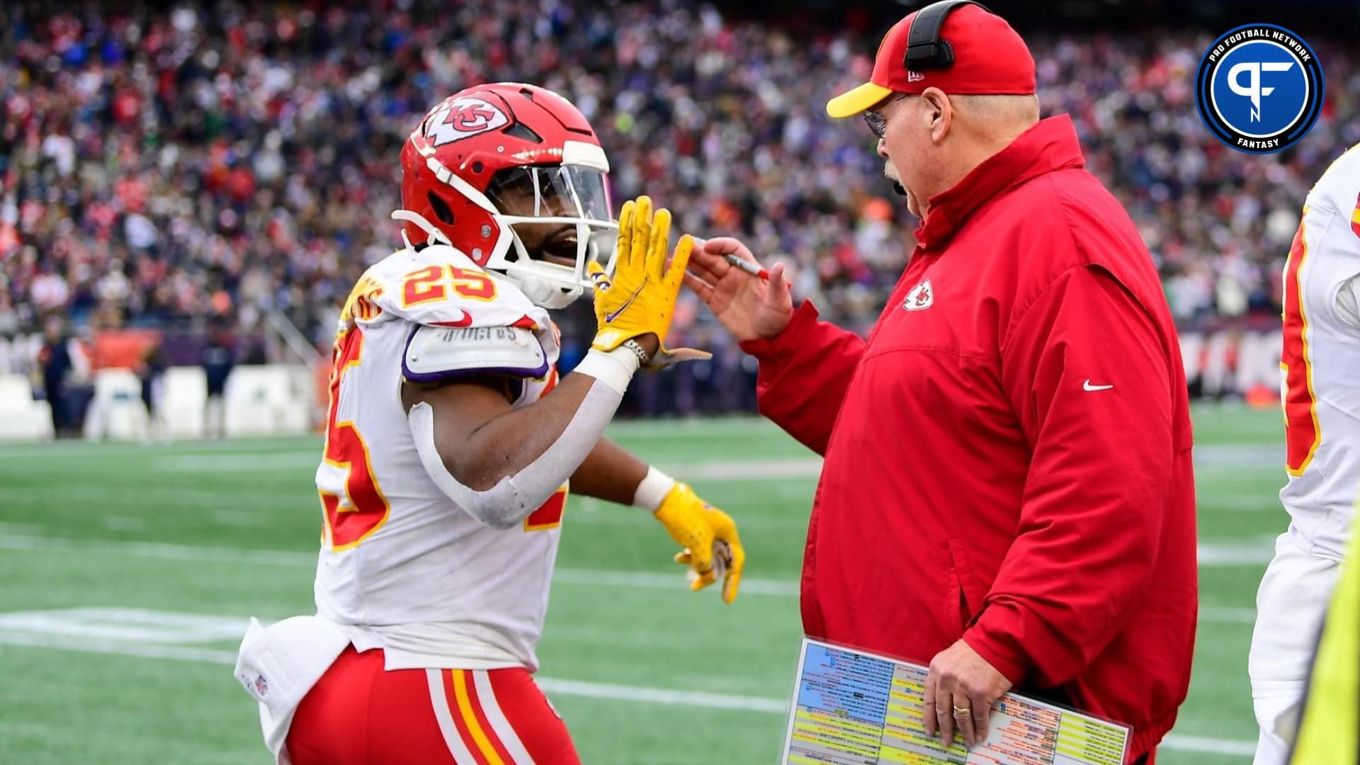 Kansas City Chiefs running back Clyde Edwards-Helaire (25) celebrates his touchdown with head coach Andy Reid during the second half against the New England Patriots at Gillette Stadium.