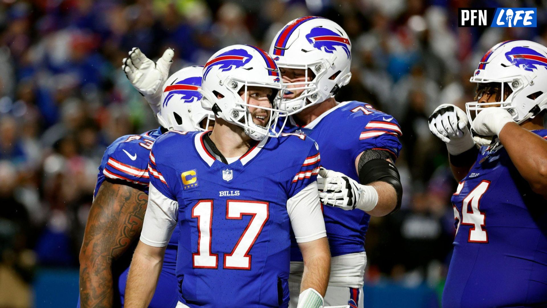 Bills quarterback Josh Allen (17) celebrates with teammates after scoring on a rushing touchdown against the Cowboys