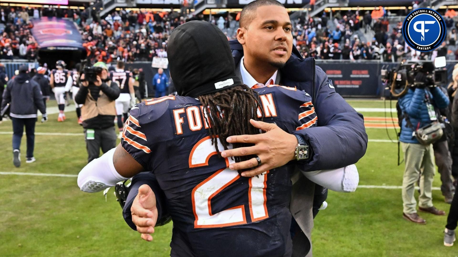Chicago Bears general manager Ryan Poles celebrates with running back D'Onta Foreman (21) after Chicago defeated the Detroit Lions at Soldier Field.