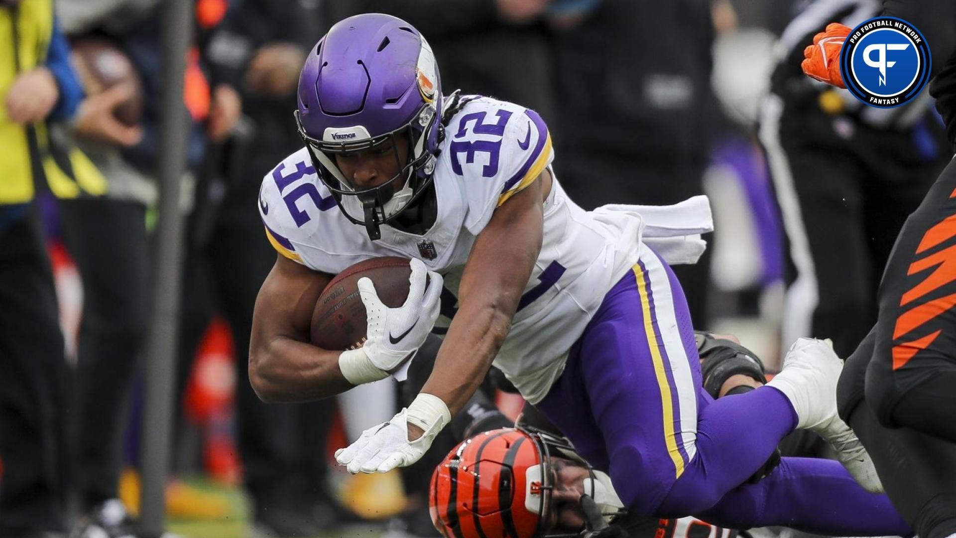 Minnesota Vikings running back Ty Chandler (32) gets tackled by Cincinnati Bengals defensive end Sam Hubbard (94) in the second half at Paycor Stadium.