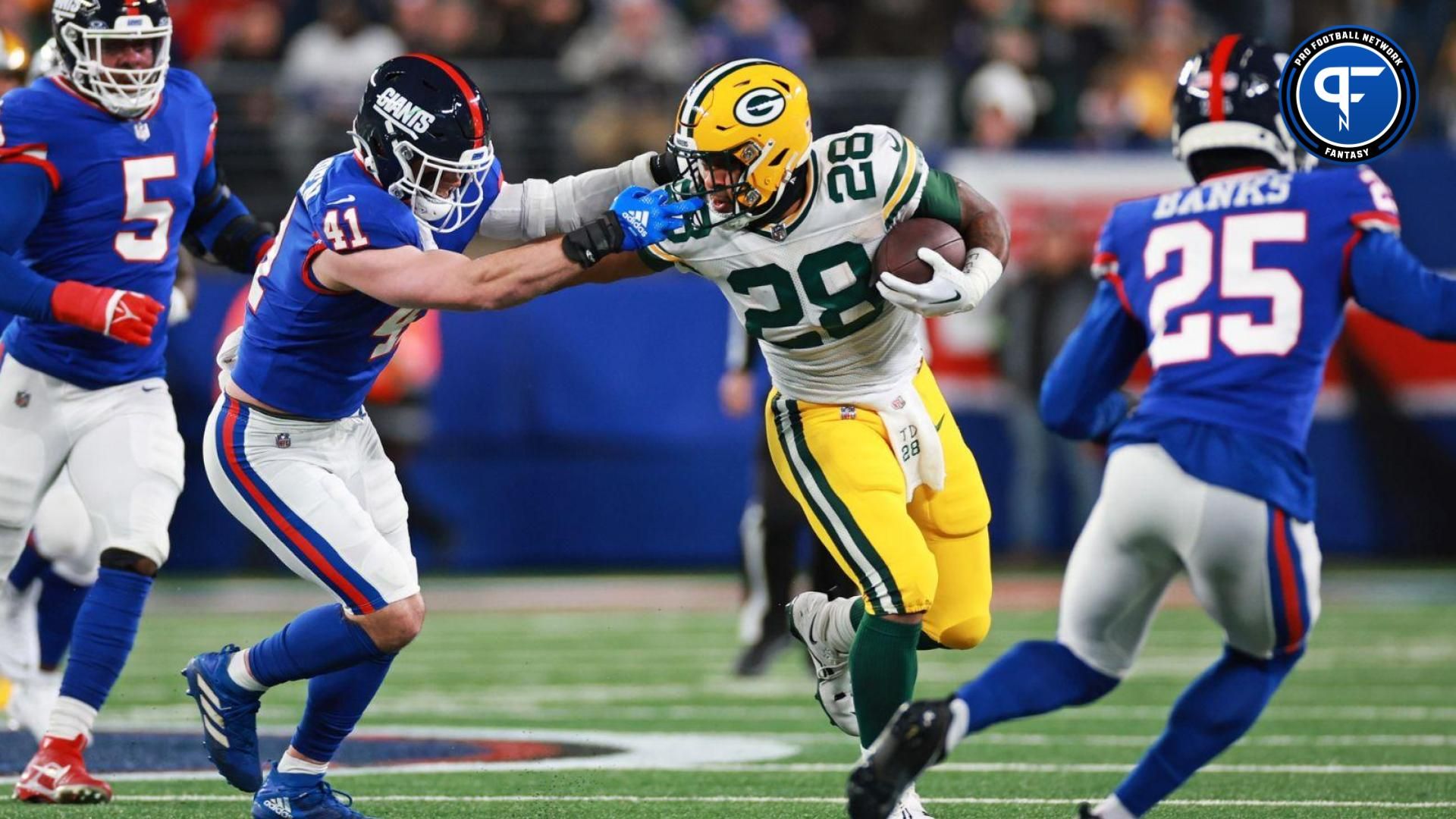 Green Bay Packers running back AJ Dillon (28) runs with the ball as New York Giants linebacker Micah McFadden (41) attempts a tackle during the second quarter at MetLife Stadium.