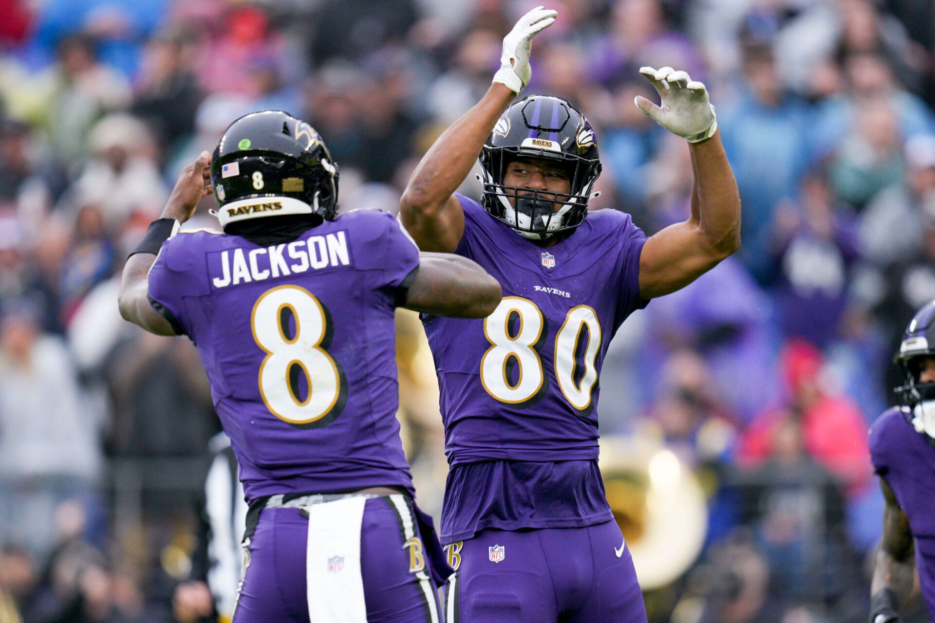 Baltimore Ravens tight end Isaiah Likely (80) celebrates a touchdown with quarterback Lamar Jackson (8) against the Los Angeles Rams during the first quarter at M&T Bank Stadium.