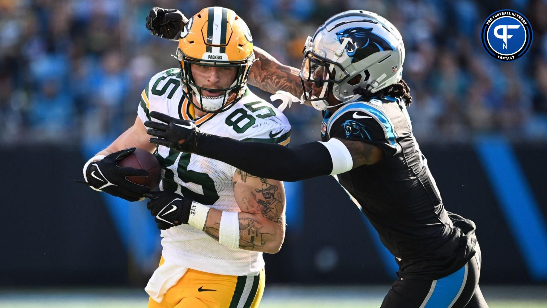 Green Bay Packers tight end Tucker Kraft (85) is tackled by Carolina Panthers linebacker Brian Burns (0) in the second quarter at Bank of America Stadium.