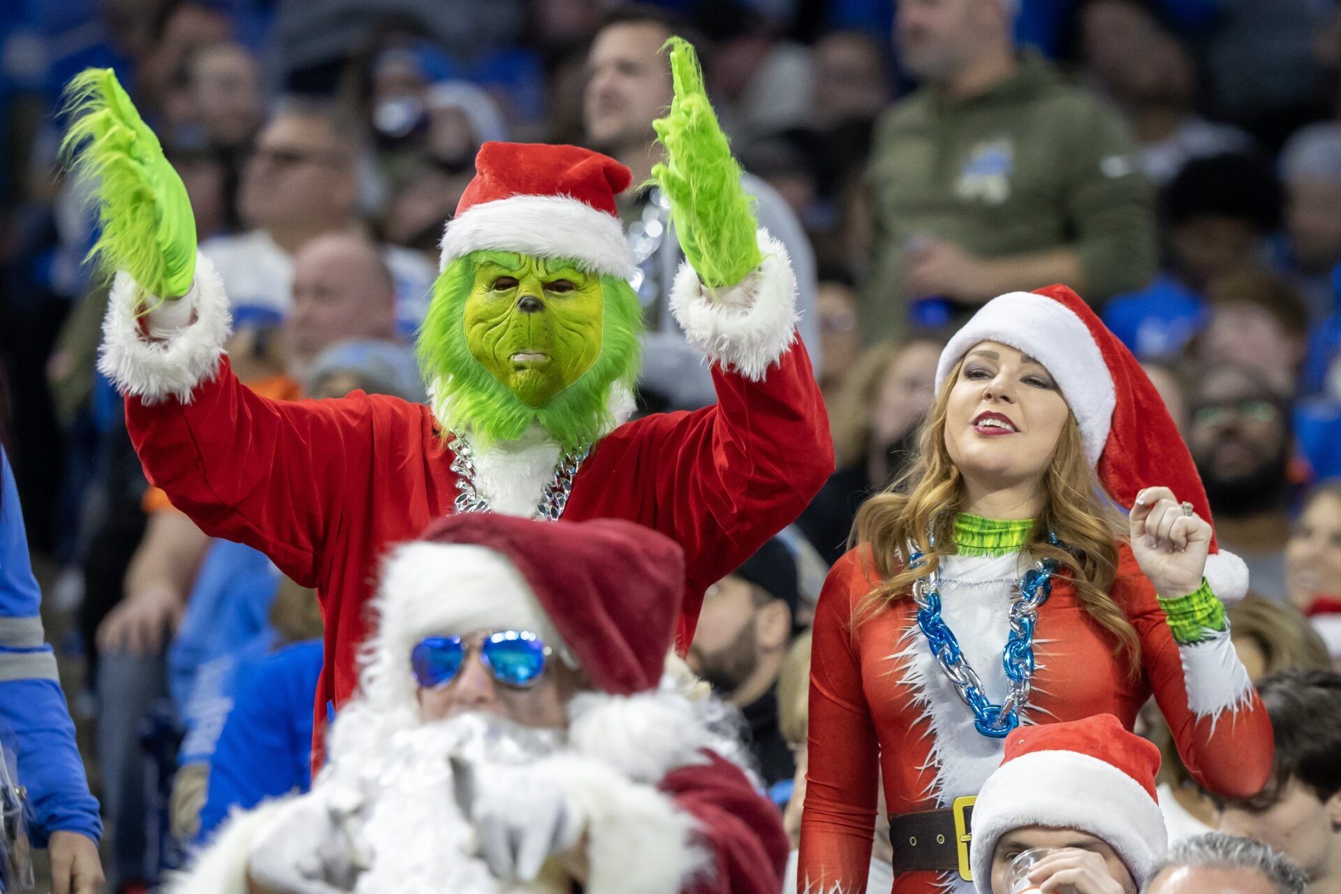 Detroit Lions fans dressed in Christmas attire react in the first half against the Denver Broncos at Ford Field.