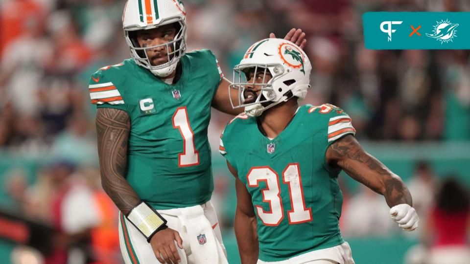 Miami Dolphins quarterback Tua Tagovailoa (1) congratulates running back Raheem Mostert (31) after scoring a touchdown against the Dallas Cowboys during the first half of an NFL game at Hard Rock Stad...