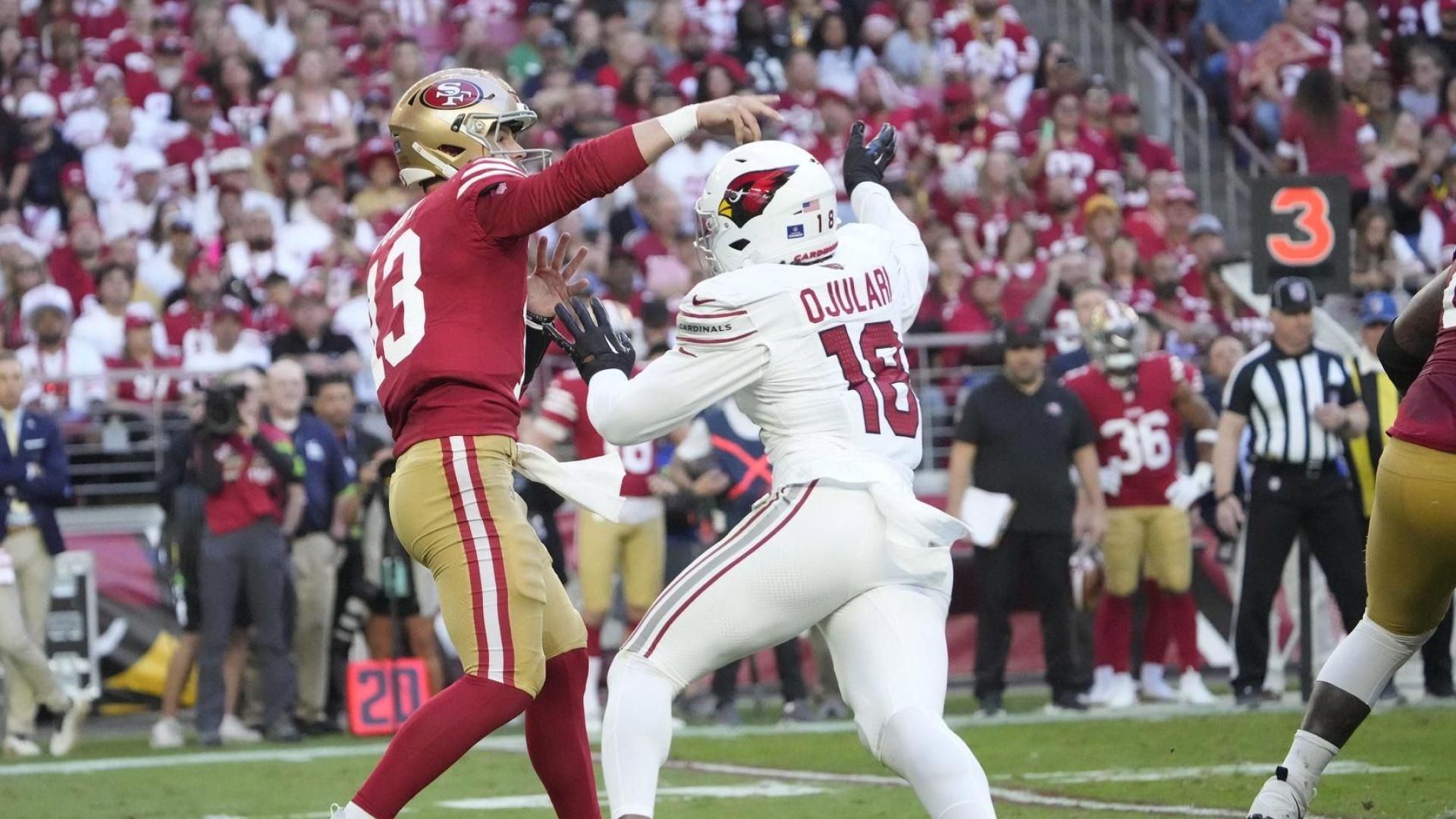 San Francisco 49ers quarterback Brock Purdy (13) throws a pass while pressured by Arizona Cardinals linebacker BJ Ojulari (18) during the third quarter at State Farm Stadium.