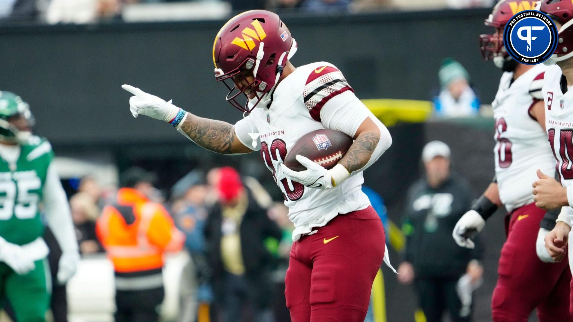 Washington Commanders running back Chris Rodriguez Jr. (23), celebrates seconds after scoring the only touchdown for his team in the first half.