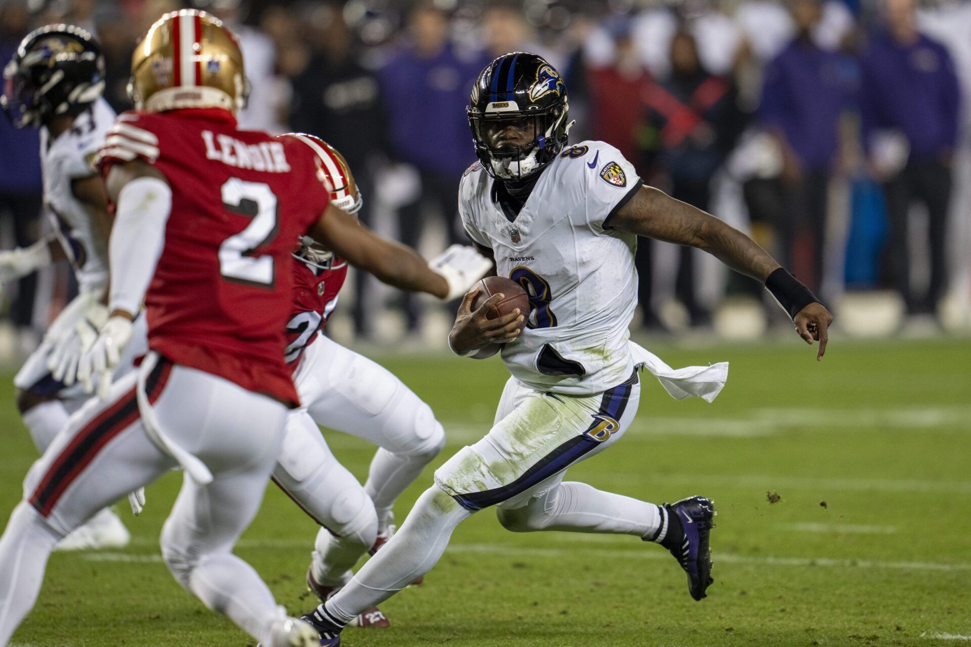 Baltimore Ravens quarterback Lamar Jackson (8) scrambles with the football against San Francisco 49ers safety Ji'Ayir Brown (27) during the second quarter at Levi's Stadium.