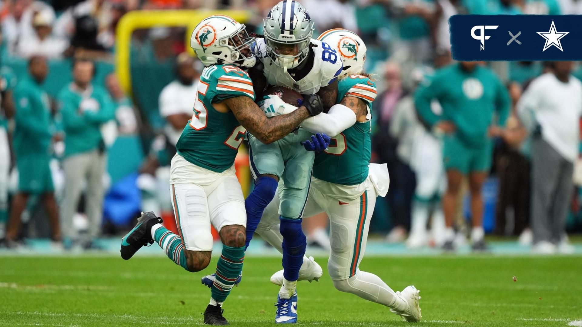 Dallas Cowboys WR CeeDee Lamb (88) gets tackled by Miami Dolphins CB Xavien Howard (25) and LB Duke Riley (45).