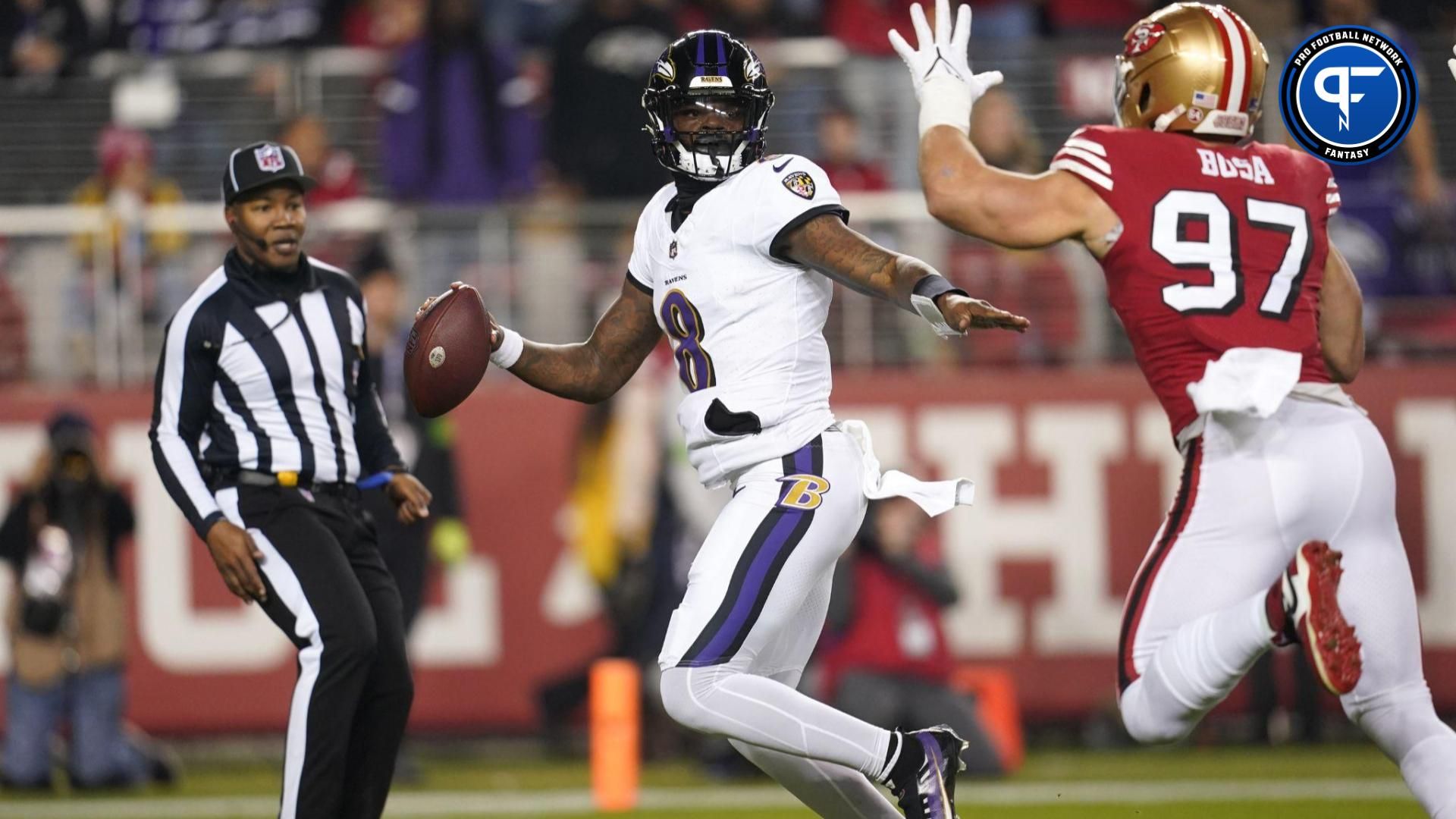 Baltimore Ravens quarterback Lamar Jackson (8) tries to elude San Francisco 49ers defensive end Nick Bosa (97) in the first quarter at Levi's Stadium.