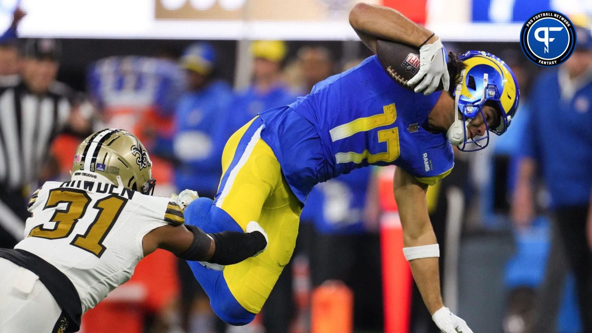 Los Angeles Rams wide receiver Puka Nacua (17) carries the ball against New Orleans Saints safety Jordan Howden (31) in the first half at SoFi Stadium.