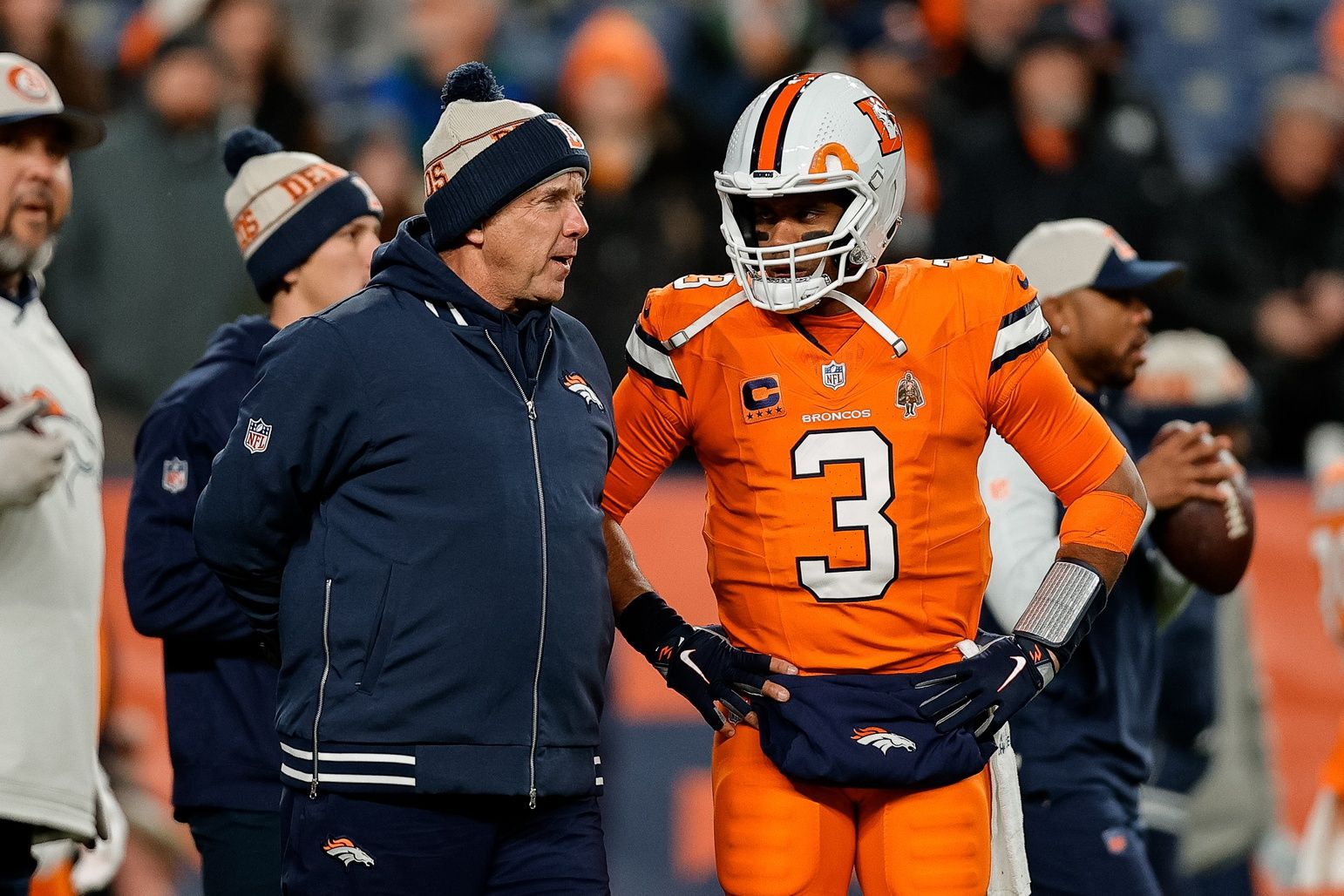 Denver Broncos head coach Sean Payton talks with quarterback Russell Wilson (3) before the game against the New England Patriots at Empower Field at Mile High.