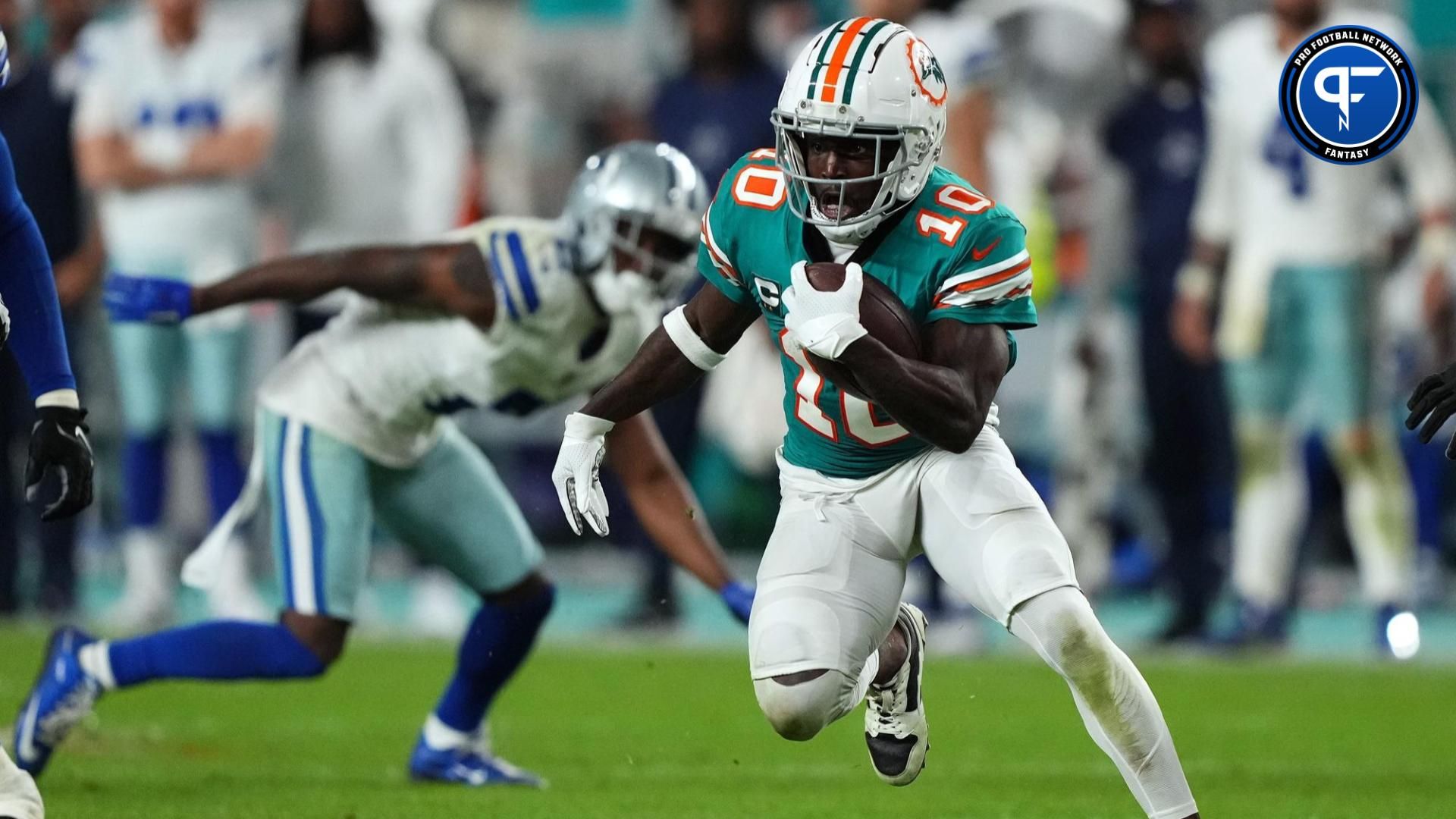 Miami Dolphins wide receiver Tyreek Hill (10) runs with the ball after a catch during the second half against the Dallas Cowboys at Hard Rock Stadium.