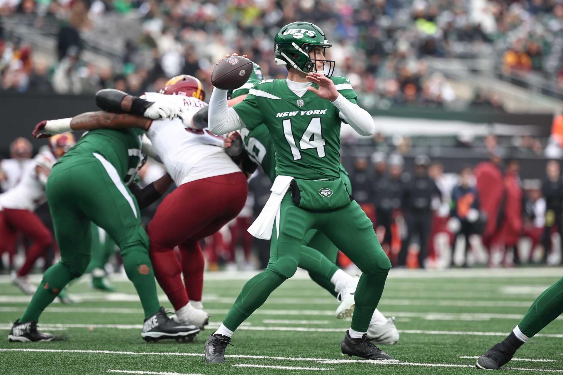 New York Jets quarterback Trevor Siemian (14) throws the ball during the first half against the Washington Commanders at MetLife Stadium.