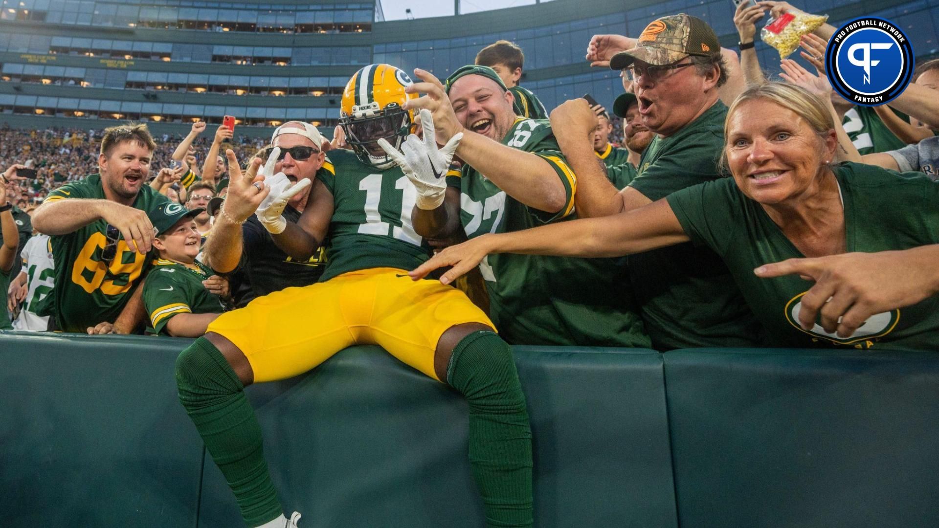 Green Bay Packers wide receiver Jayden Reed (11) celebrates his 19-yard touchdown reception with a Lambeau Leap during the second quarter of their preseason game against the New England Patriots Saturday, August 19, 2023 at Lambeau Field in Green Bay, Wis.