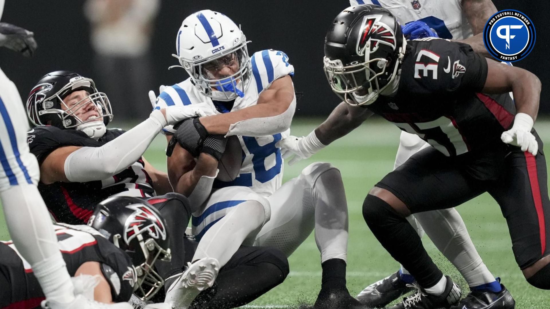 Indianapolis Colts running back Jonathan Taylor (28) is brought down by Atlanta Falcons defenders during a game against at Mercedes-Benz Stadium.