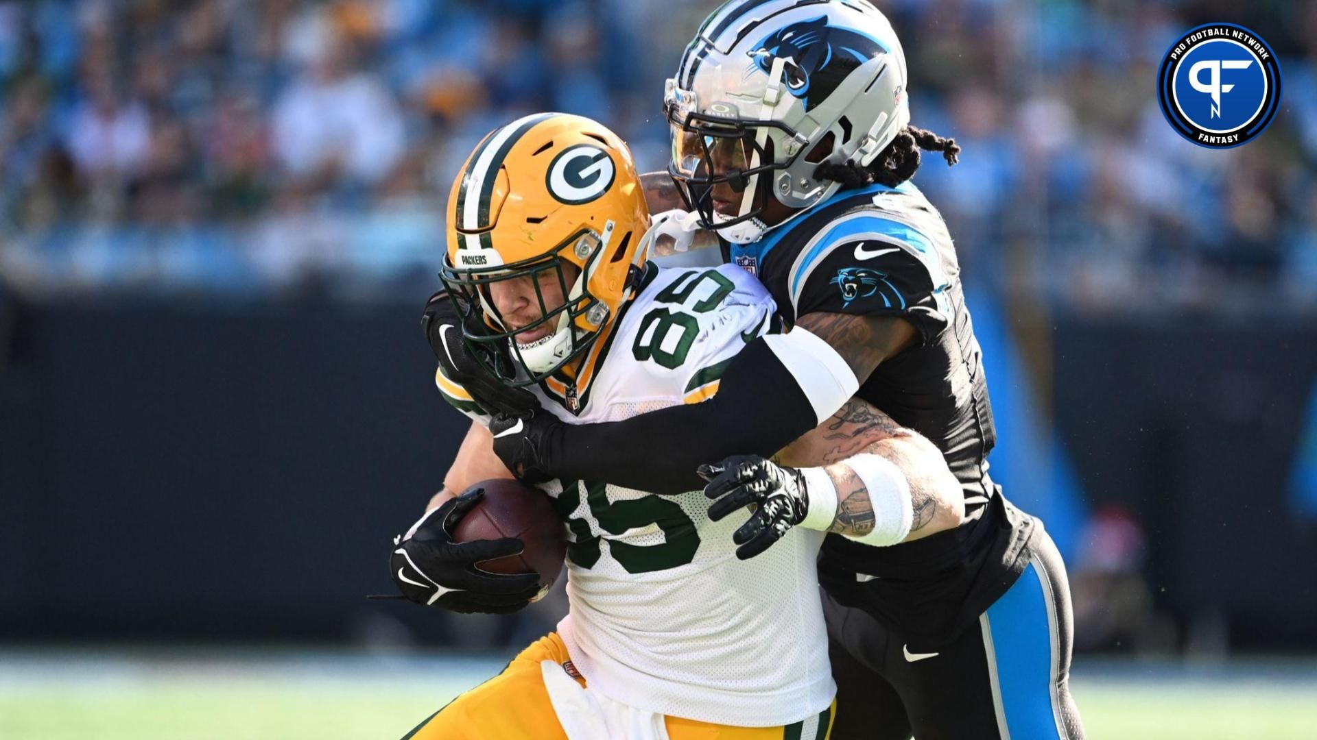 Green Bay Packers tight end Tucker Kraft (85) is tackled by Carolina Panthers cornerback Jaycee Horn (8) in the second quarter at Bank of America Stadium.